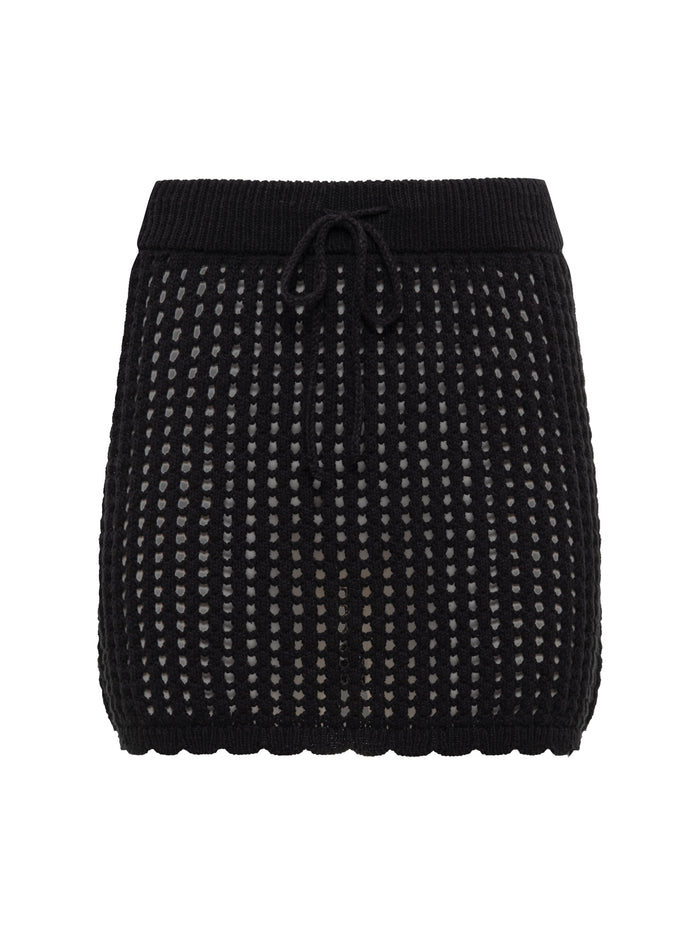 The Sanctuary Clothing beachside crochet skirt in black features a mini length, scalloped hem, drawstring waist, and dotted open-weave detailing over a light inner lining.