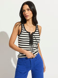 A woman with long dark hair models the Sanctuary Clothing "go to lace up tank chalk black stripe 11," a black-and-white striped sleeveless top with lace-up detail, standing against a plain white background.
