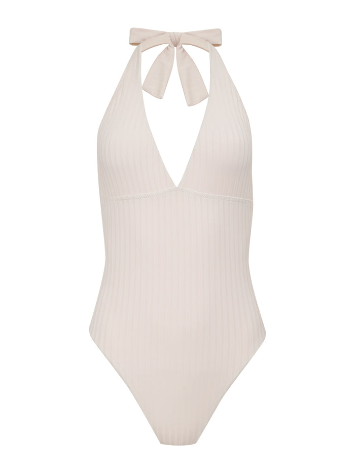 The Sanctuary Clothing Halter Mio One Piece in White Sand features a light beige ribbed fabric, deep V-neckline, and halter neck tie, shown against a white background.