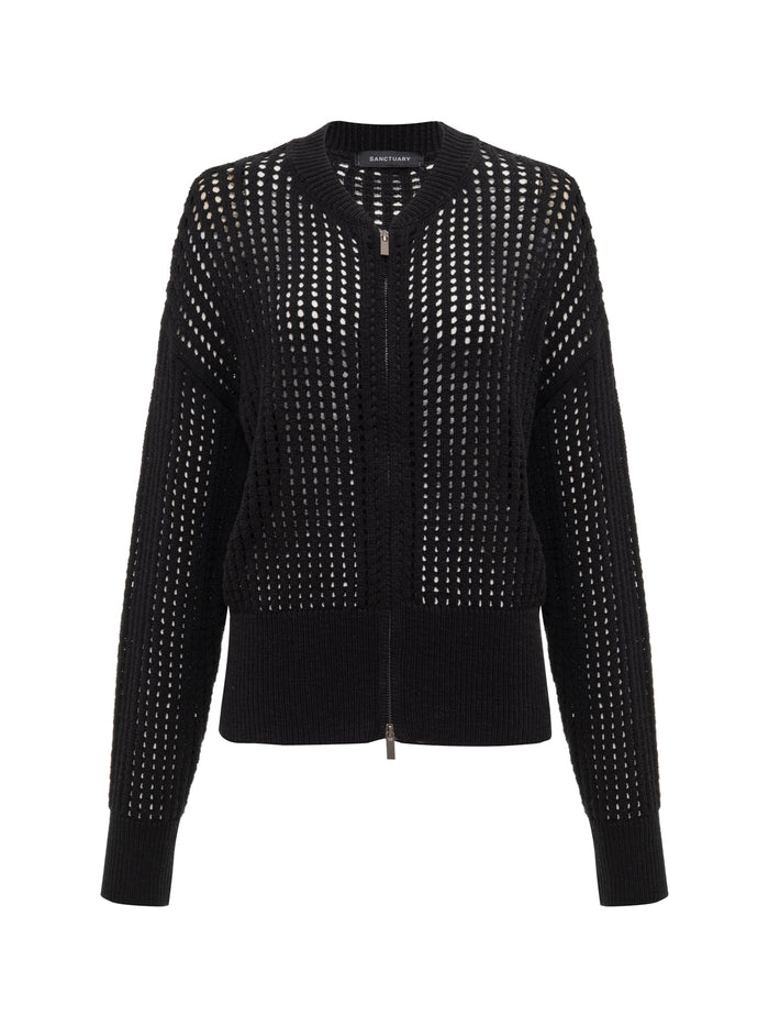 The Sanctuary Clothing laguna openwork bomber in black (petite sizing) features a perforated, open-weave knit, front zipper, and ribbed hem, cuffs, and collar for contrast. Lightweight and stylish—perfect for layering.