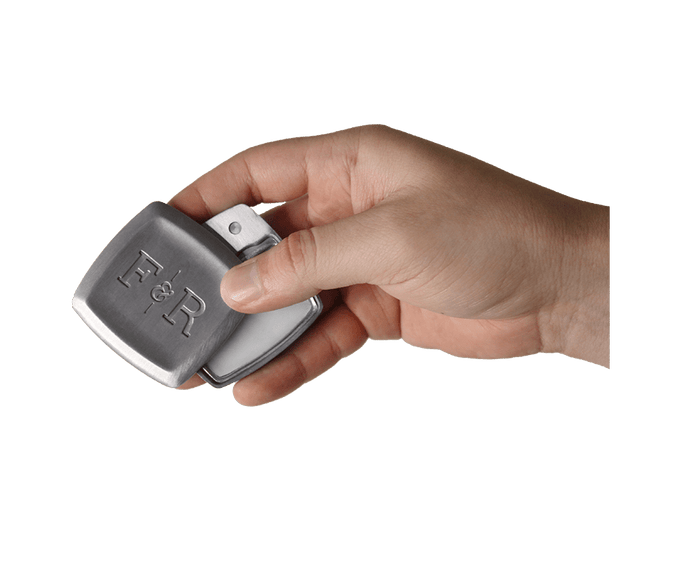 Hand holding a half open Fulton & Roark solid fragrance