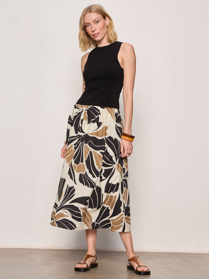 A woman poses against a plain background wearing the Sanctuary Clothing sandbar mix media midi dress in lotus w black.