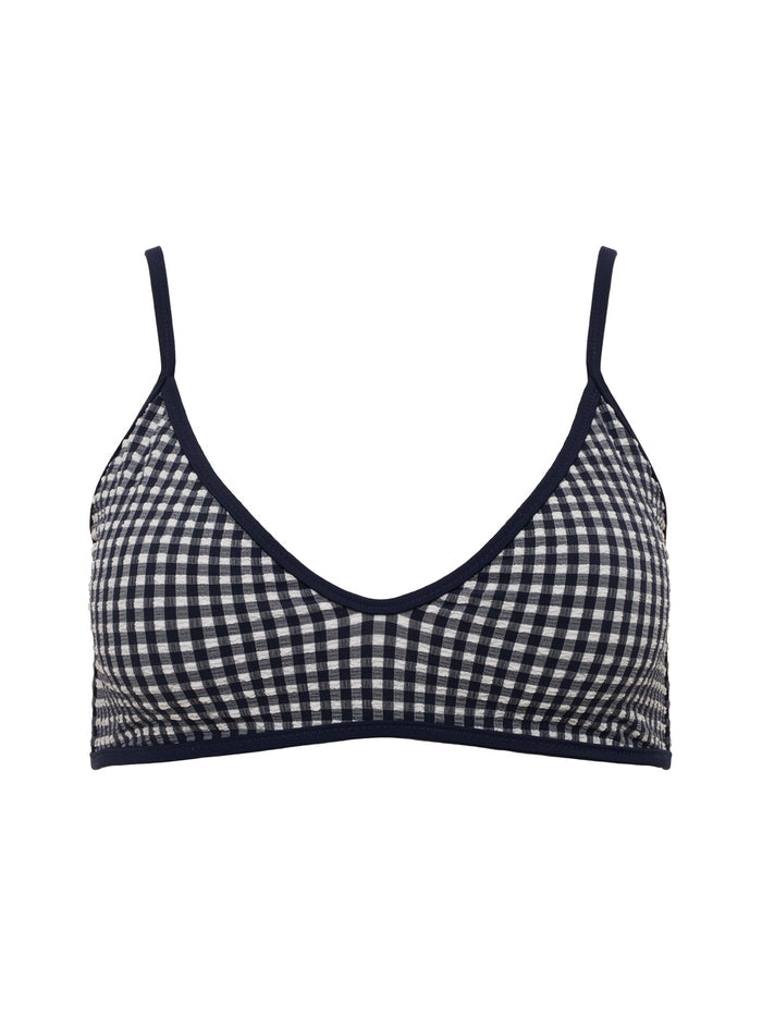 A navy scoop front bra bikini top by Sanctuary Clothing with thin spaghetti straps and black trim.