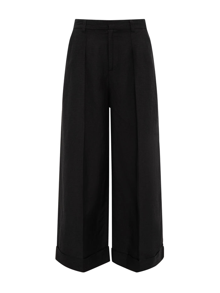 Sanctuary Clothing’s terrace linen pant in black features a high-waist, wide-leg silhouette with pressed creases and cuffed hems, shown against a white background.