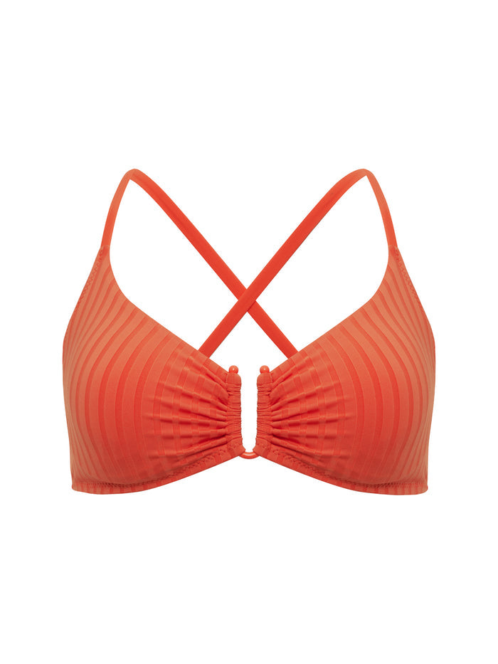 The Sanctuary Clothing underwire bra bikini top in hibiscus features subtle vertical stripes, a ruched center, adjustable crisscross back straps, and stretchy unpadded fabric.